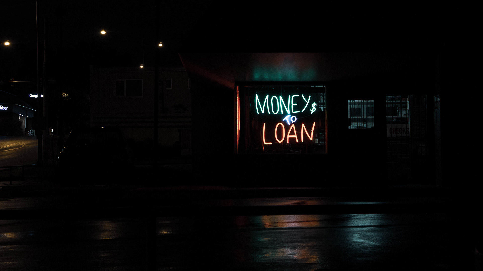 Neon sign reads "Money to Load"