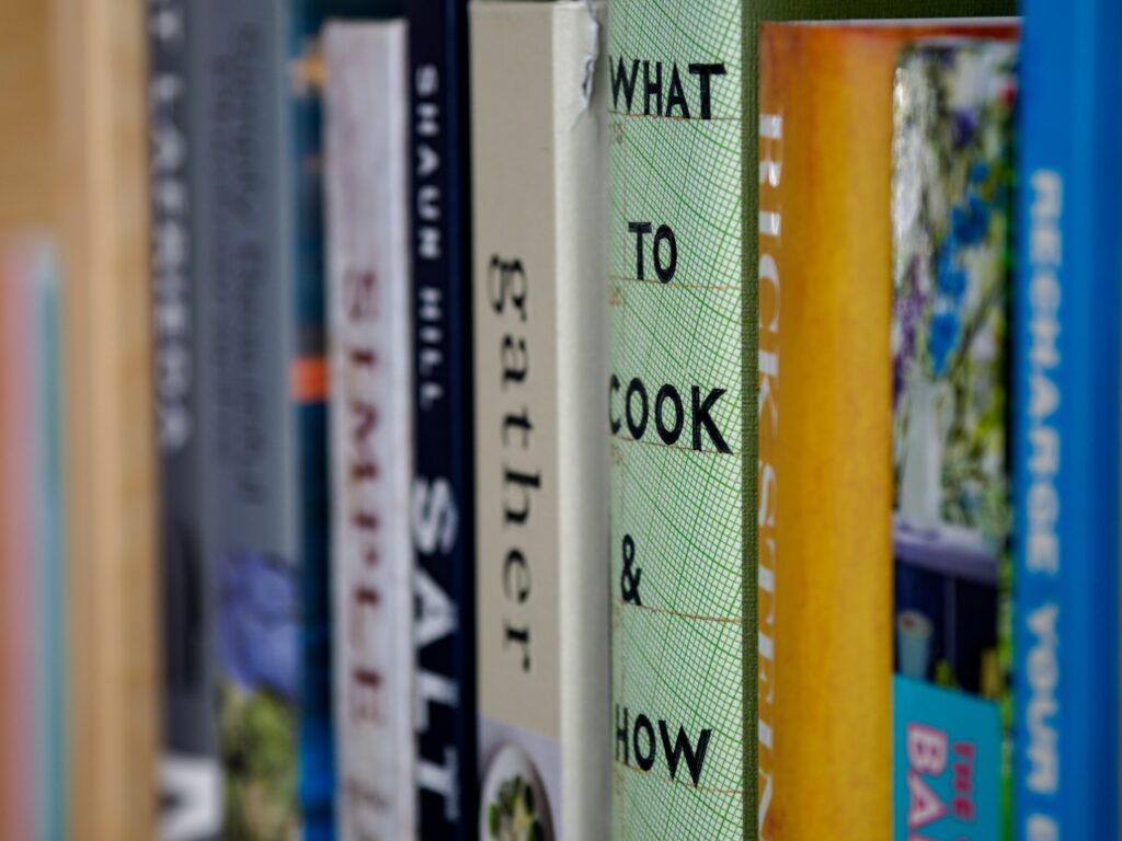 An image of books lined up on a shelf