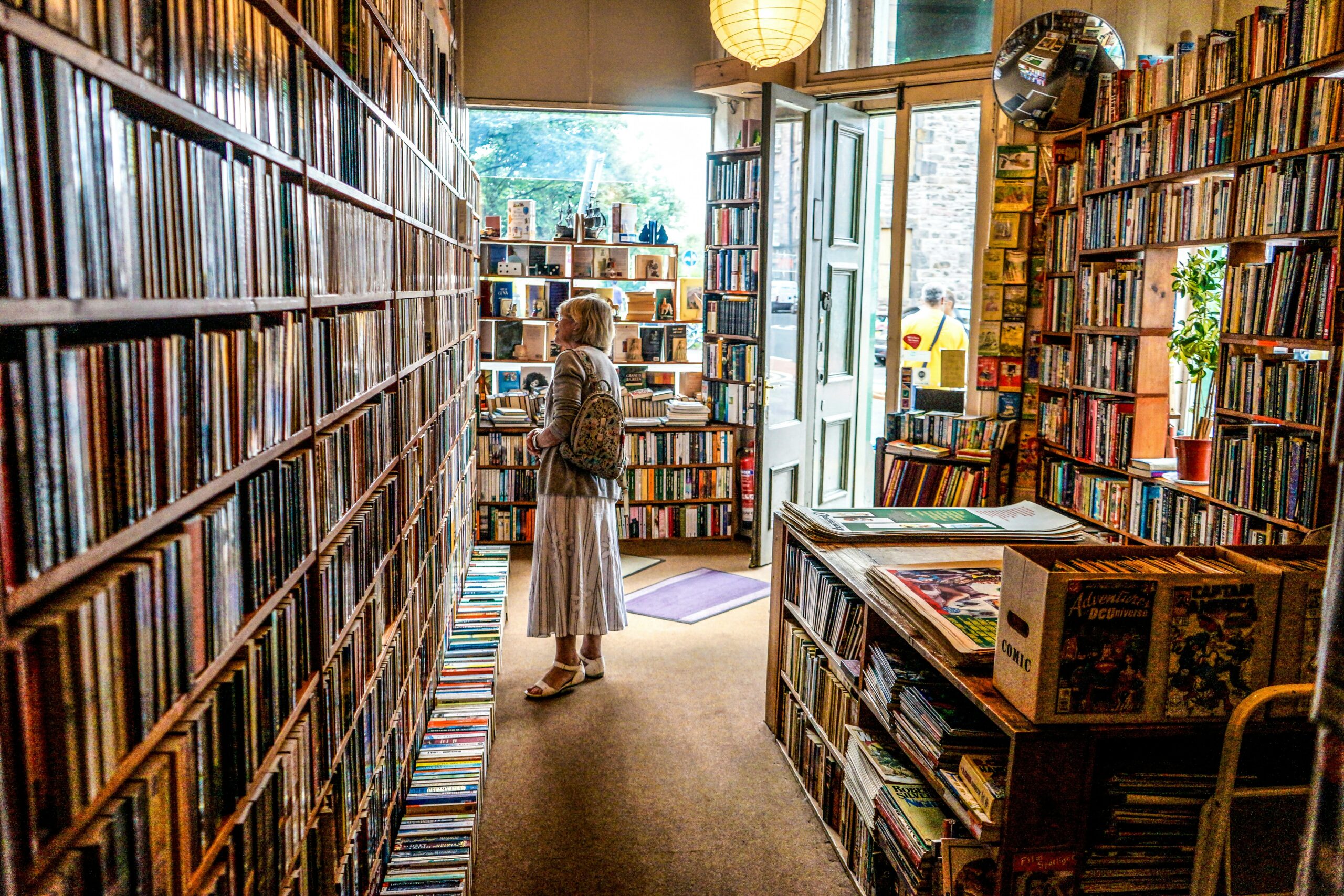 A photograph of a woman shopping in a bookstore.