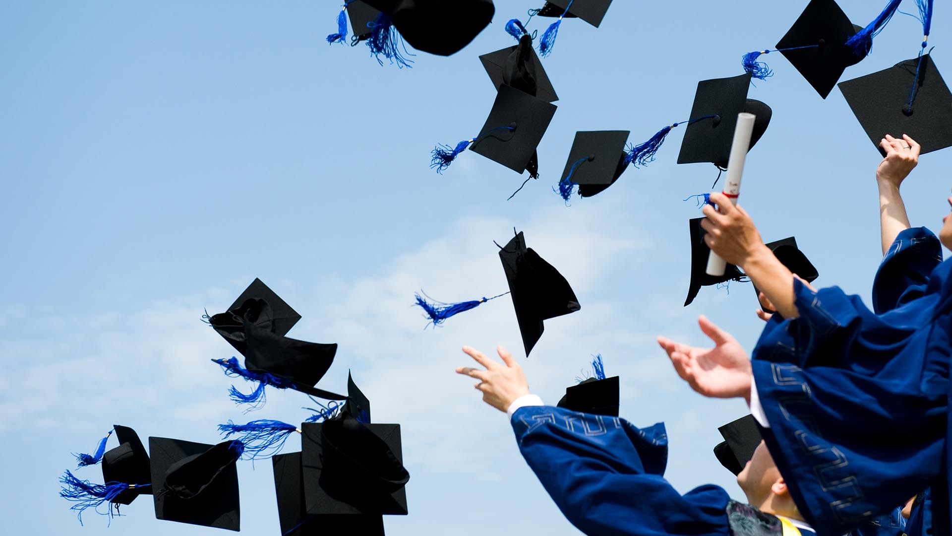 Photo of students graduating. Is college worth it?